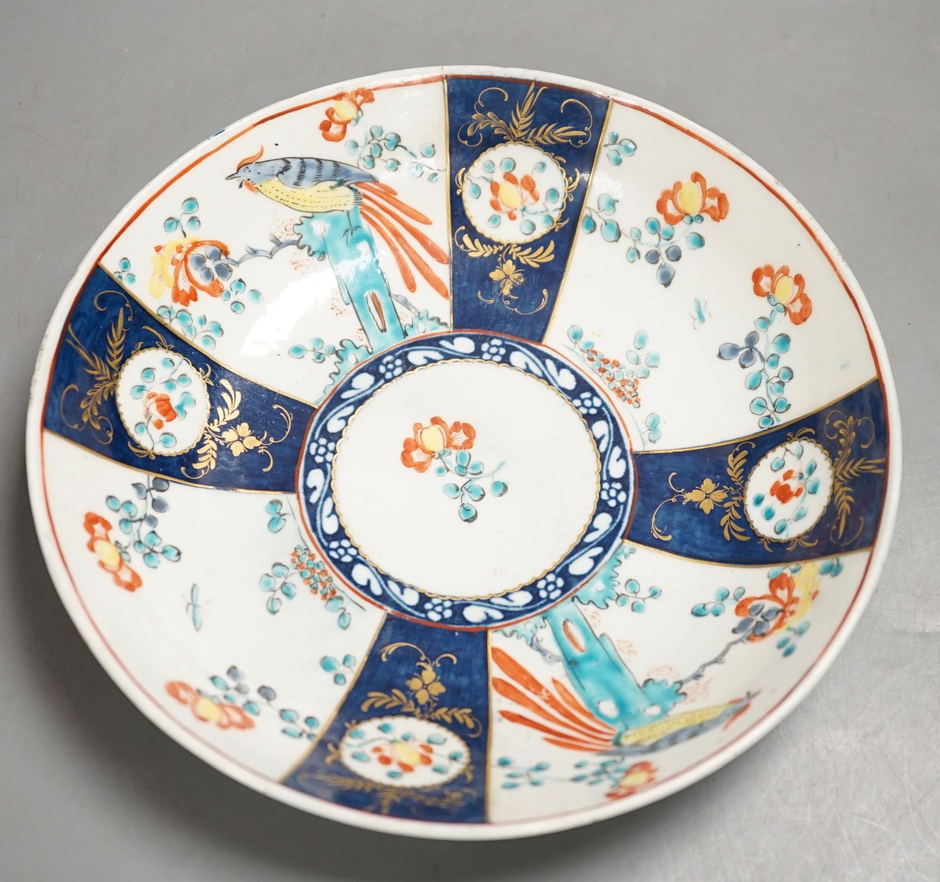 A Worcester saucer shaped dish painted with the blue panelled version of the Sir Joshua Reynolds pattern c.1765-70, 19cm